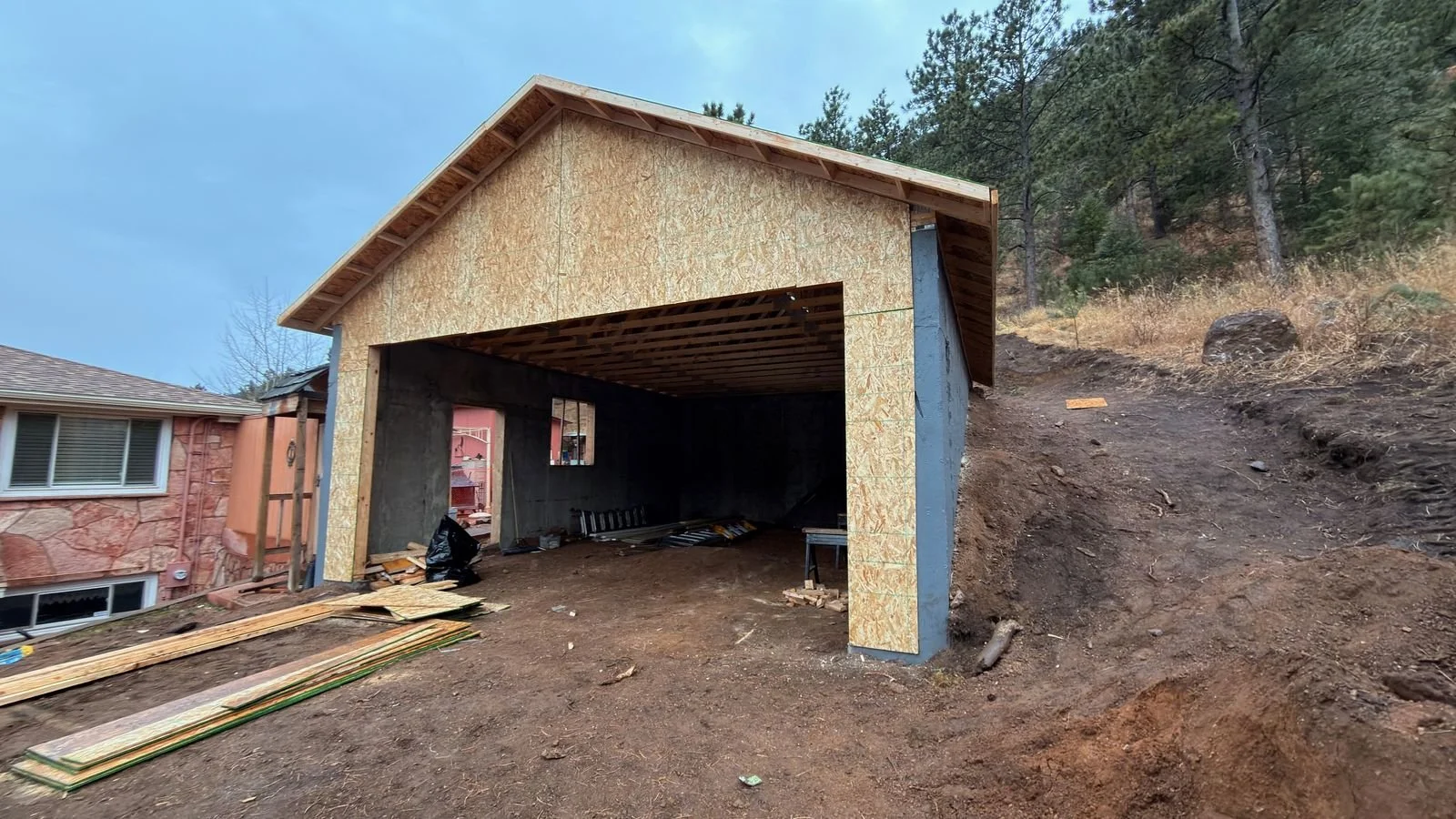 Framed and sheathed detached garage with an open front