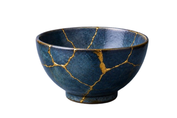 A kintsugi bowl repaired with gold seams along its cracks