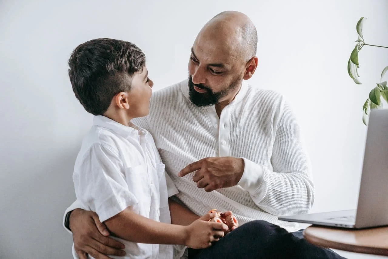 man-wearing-a-white-sweater-with child
