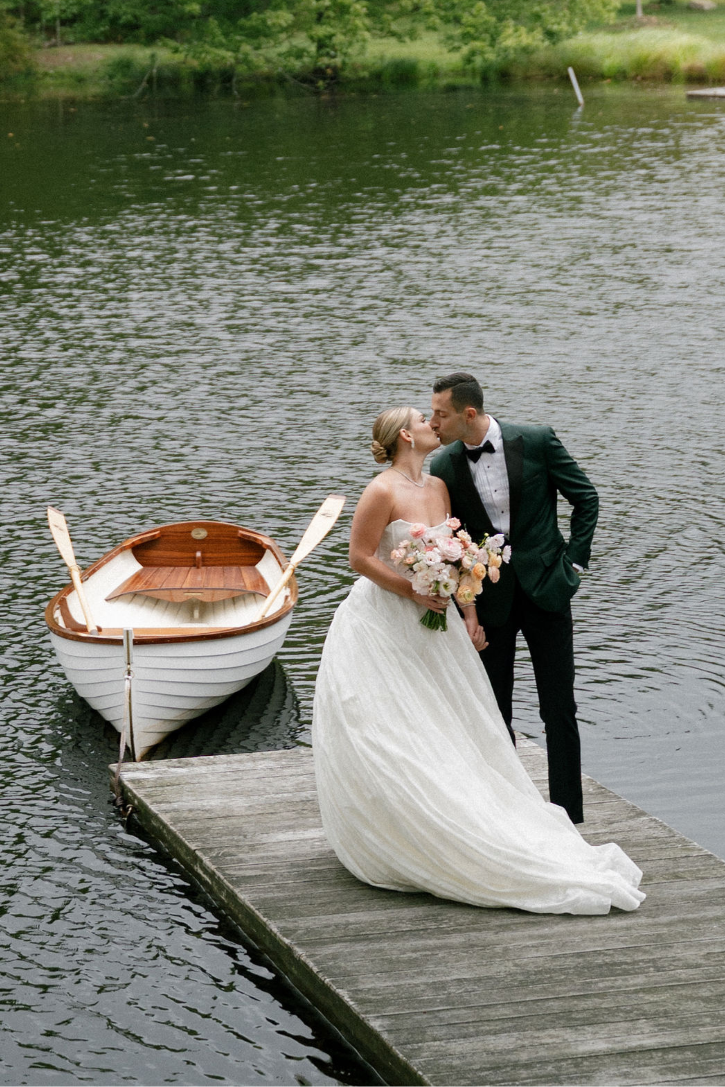 Couple Kissing on a Dock at a Luxury Wedding Planned by Faith Ferguson Productions