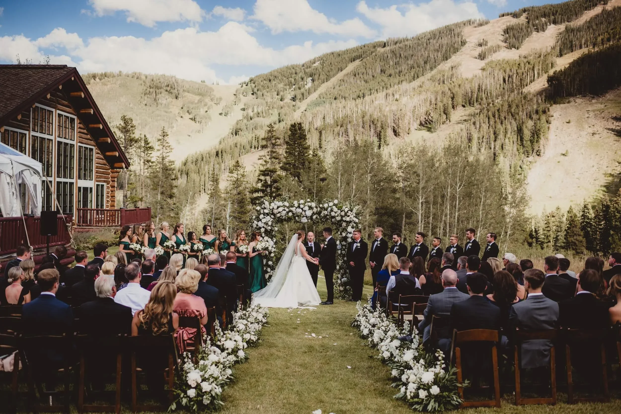 Wedding Ceremony with Mountains in Background at Colorado Destination Wedding Planned by Faith Ferguson Productions