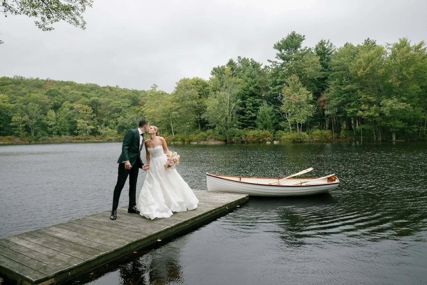 Bride and Groom Kissing on a Dock at a Luxury Wedding in New York Planned by Faith Ferguson Productions