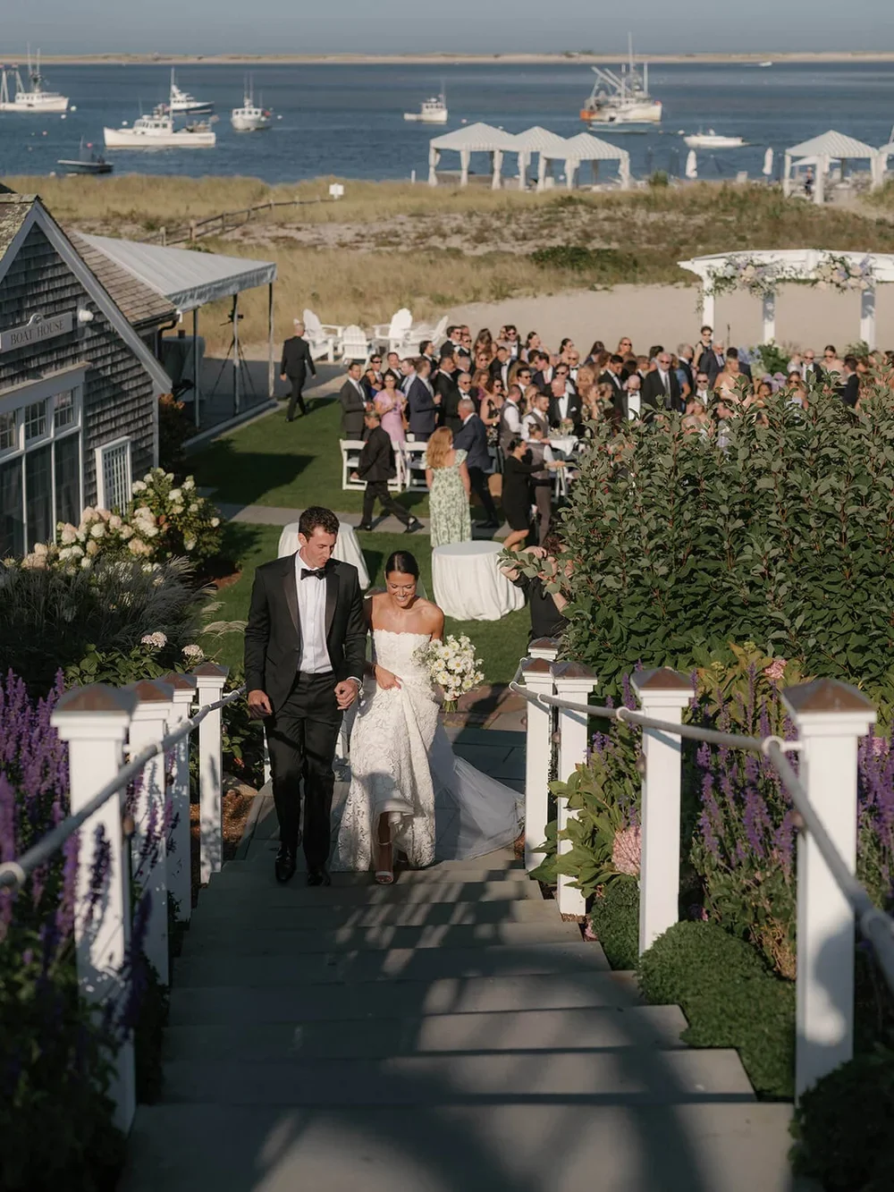 Bride and Groom Walking Up Steps at a Cape Cod Destination Wedding Planned by Faith Ferguson Productions