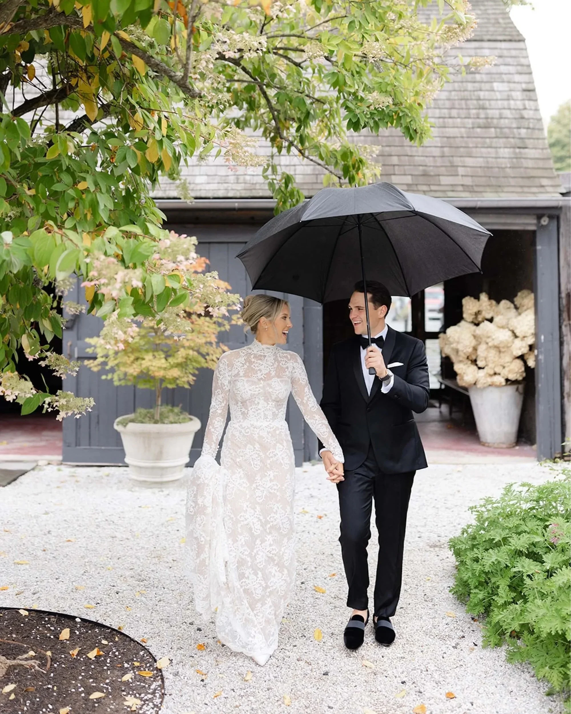Bride and Groom Under an Umbrella Outside Valley Rock Inn & Mountain Club at a Luxury Wedding Planned by Faith Ferguson Productions