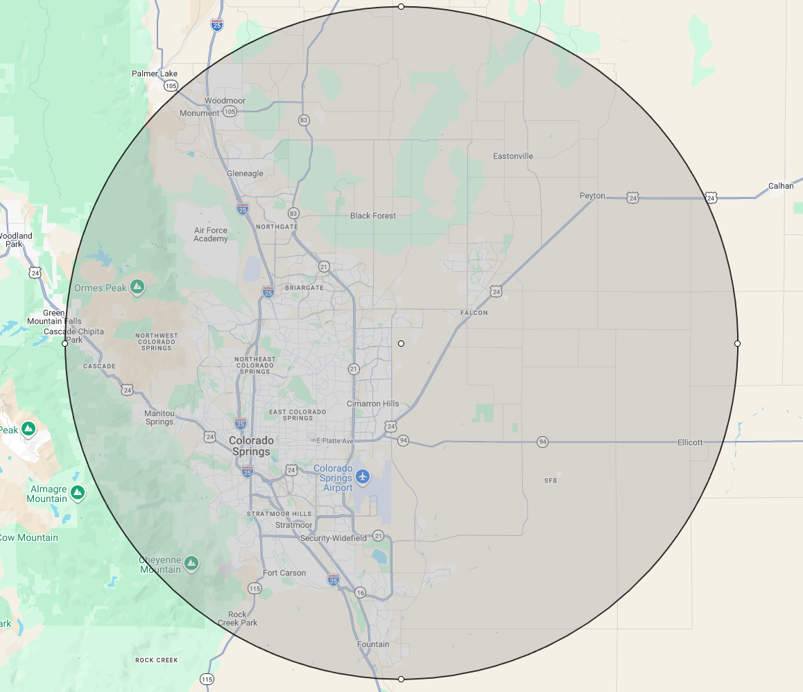 Map showing the area around Colorado Springs, Colorado, with a shaded circle overlay indicating a specific radius from the city center.