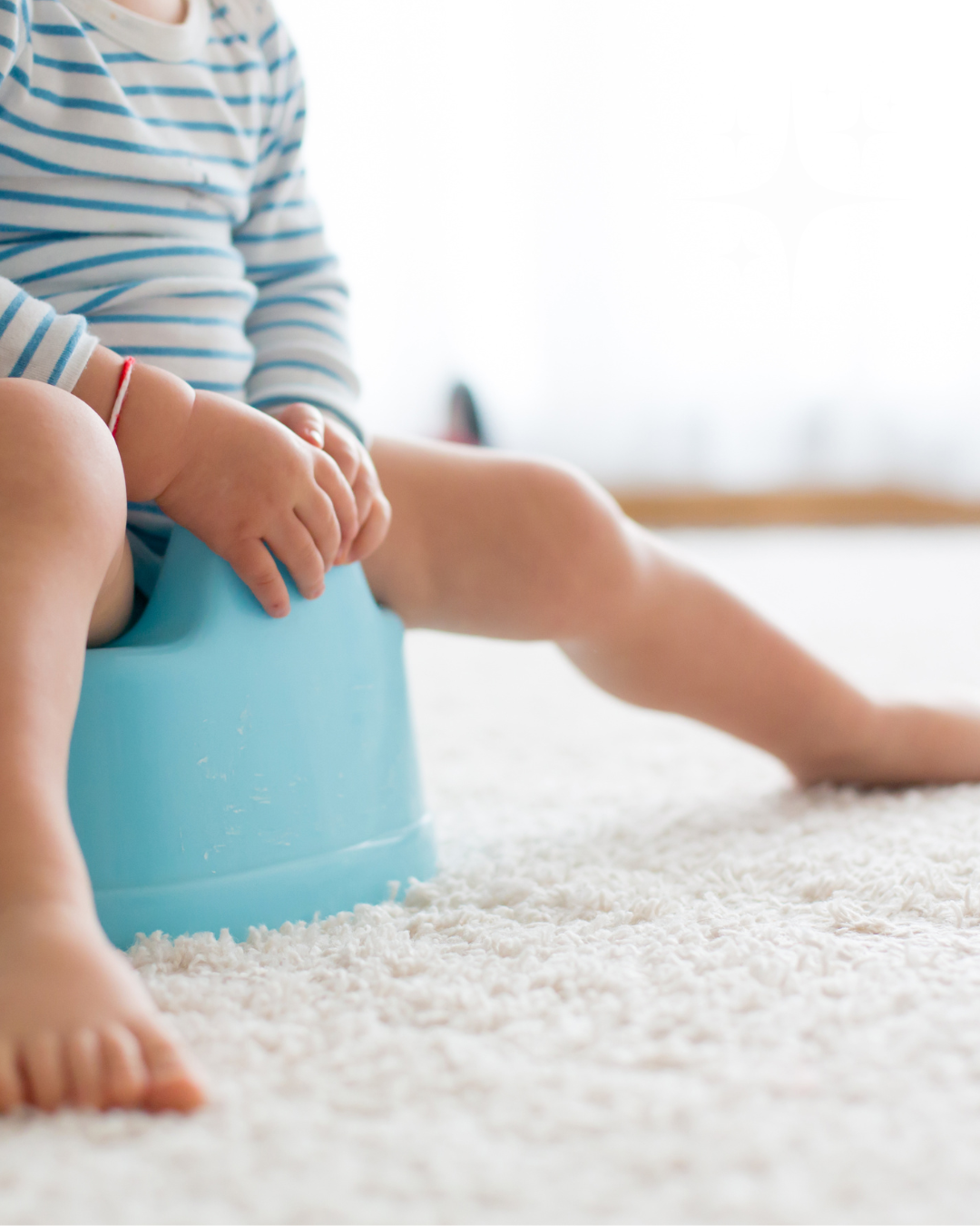 A baby sitting on a blue potty seat, wearing a striped shirt, with one leg extended and barefoot, on a white plush carpet in a bright room.