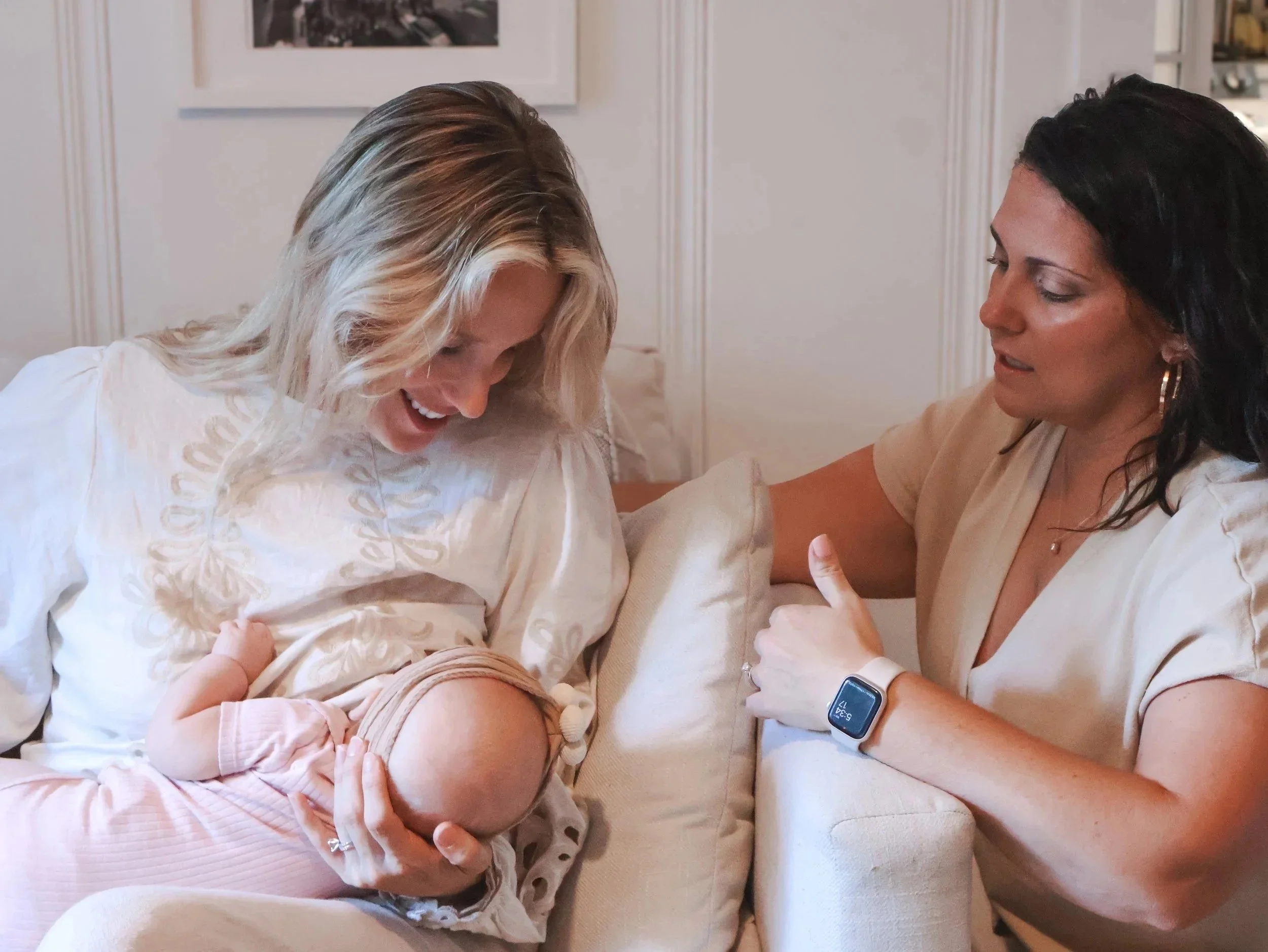 Occupational Therapist and Lactation expert supporting new mom and newborn during in-home visit in Charlotte, NC