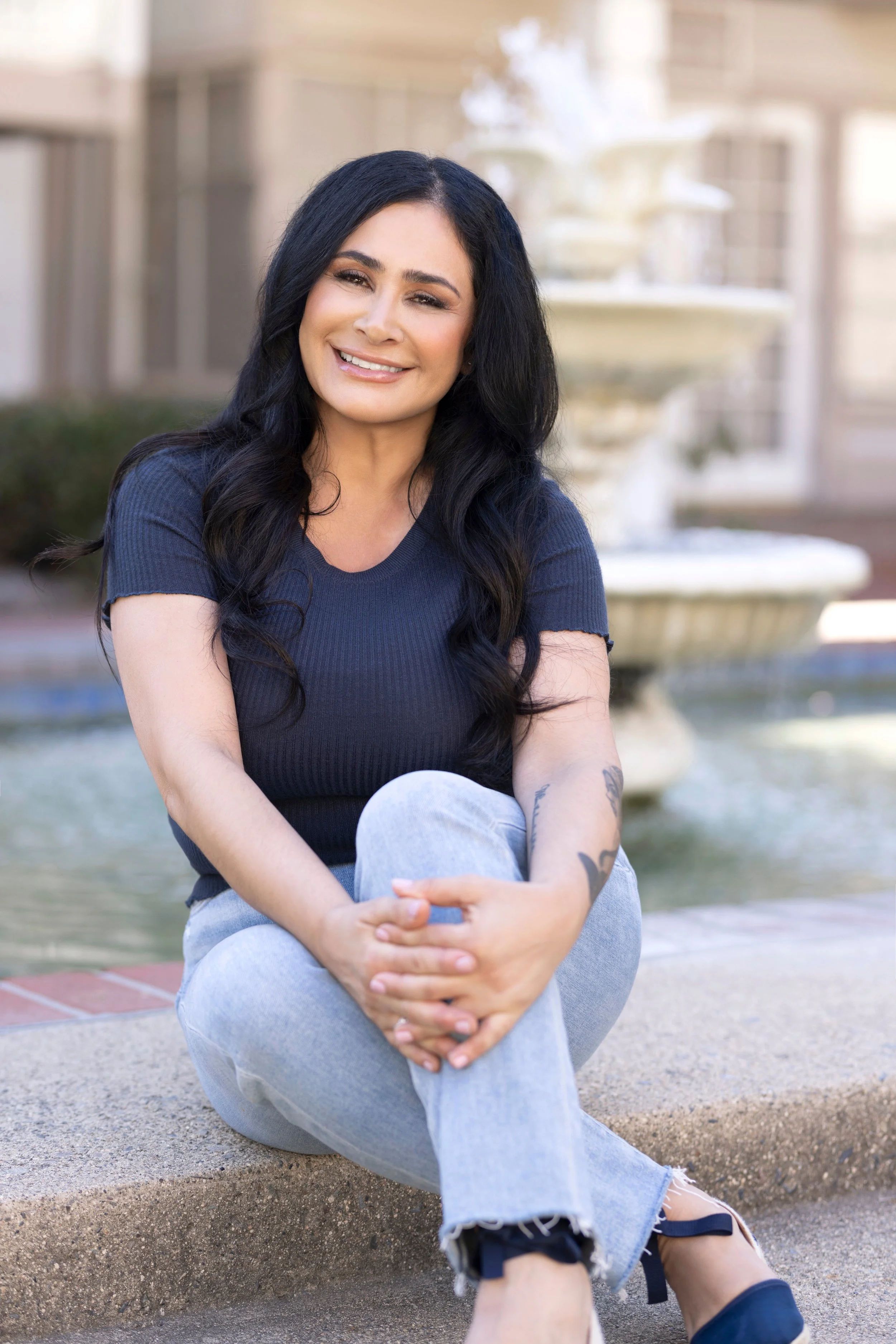 Bahareh Saidian smiling warmly in a natural light headshot.