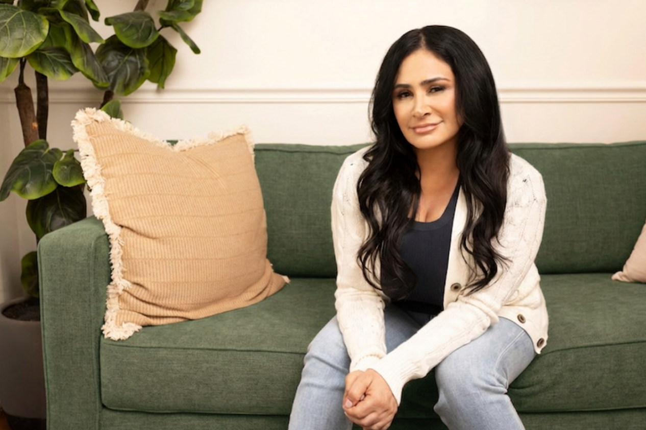 Bahareh Saidian seated in an Irvine, CA therapy office, surrounded by warm, earthy decor.