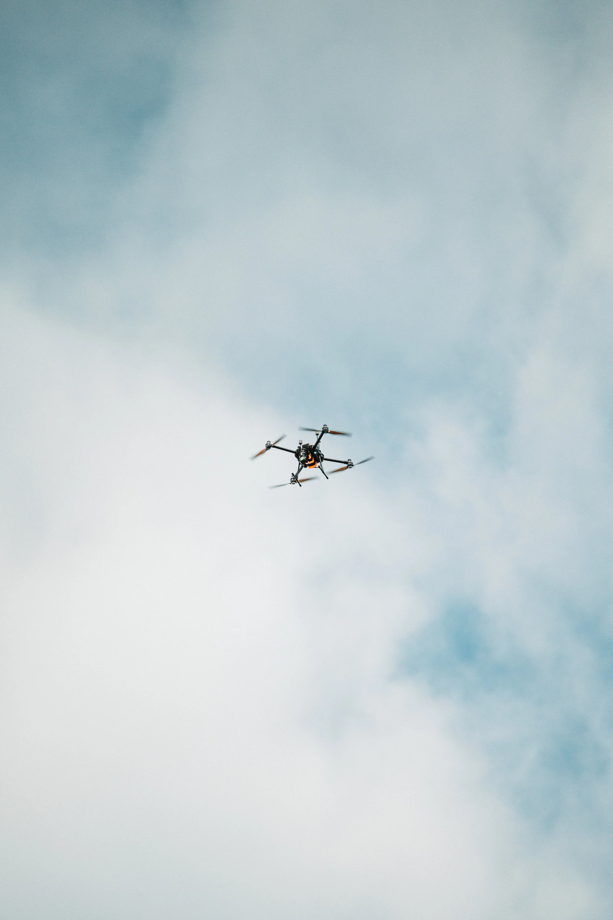 Rainmaker drone flying against a backdrop of wispy clouds.
PC: Nicholas Abegg-Guzman