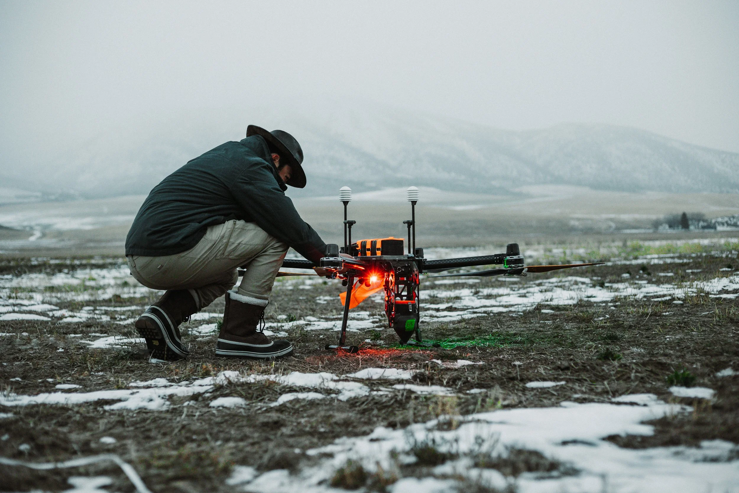 Raimaker drone pilot inspecting a powered drone before flight.
PC: Nicholas Abegg-Guzman