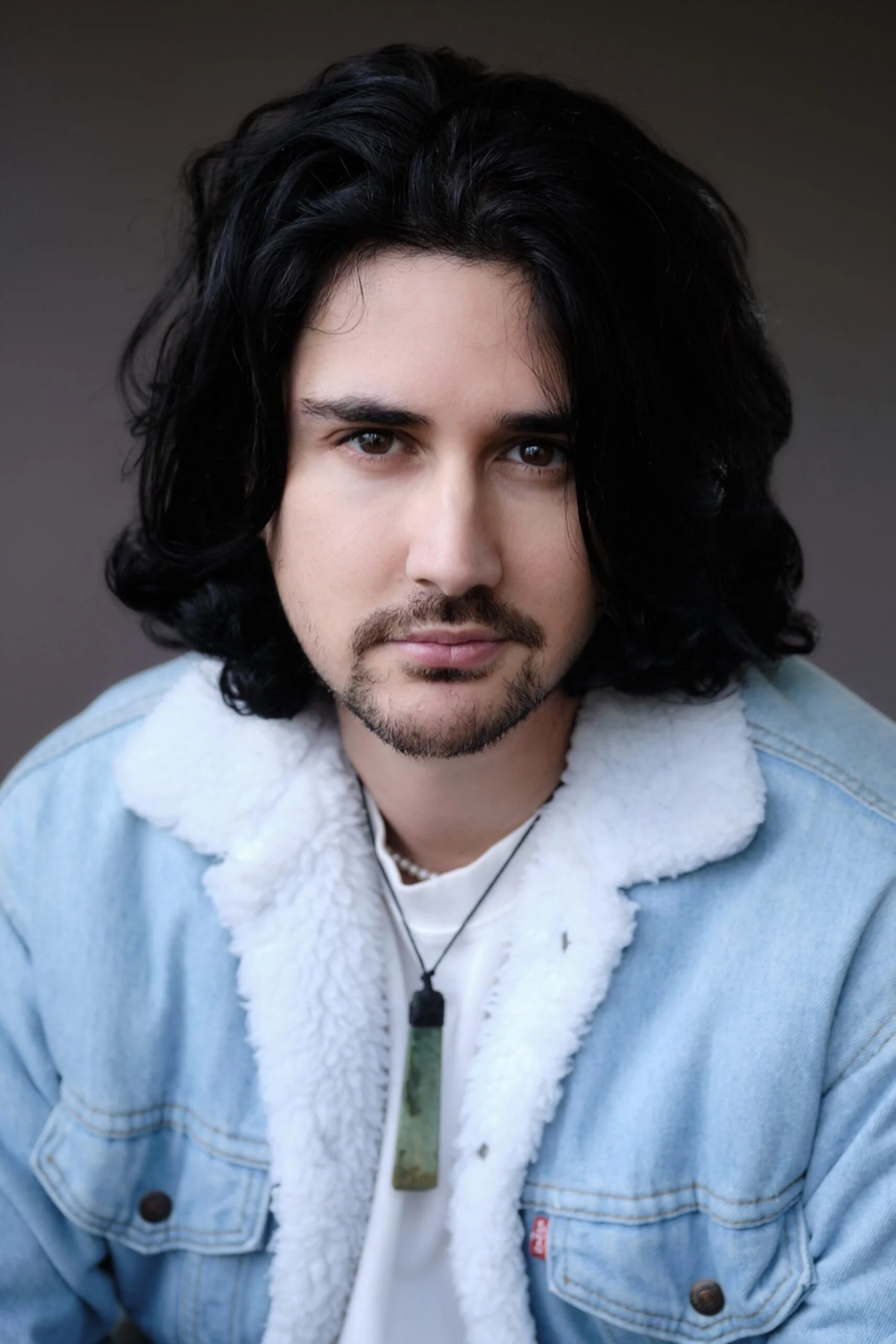 A photo of Nathan Mudge wearing a blue jacket with wool lining.
