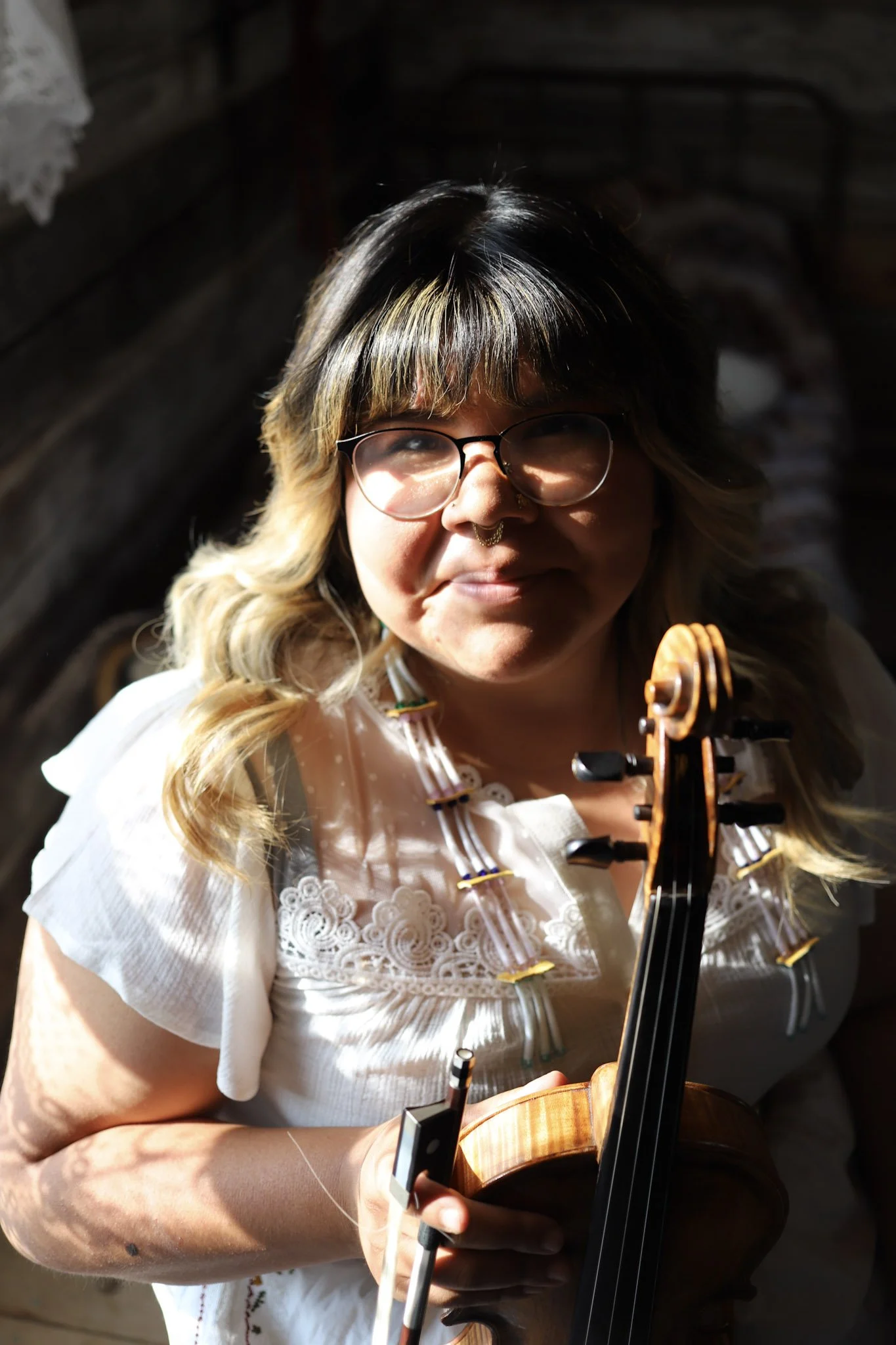 A press photo of Brianna Lizotte holding a fiddle.