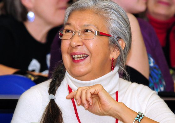 Candid photo of Louise Lahache looking off camera and smiling.