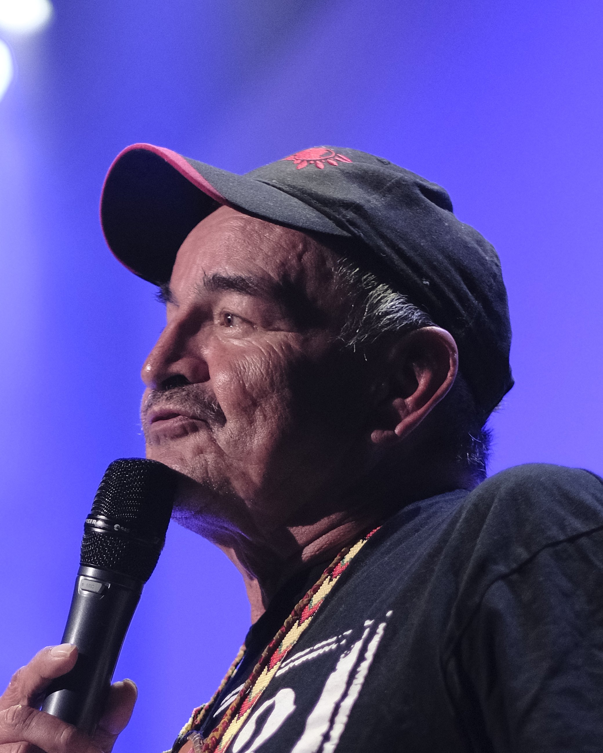 Close-up photo of Gerard Sagassige speaking into a microphone.
