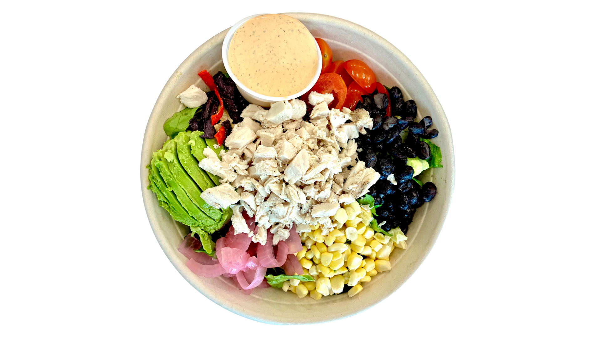 A bowl of salad containing chopped chicken, avocado slices, cherry tomatoes, black beans, corn, pickled onions, shredded beets, and a small container of dressing