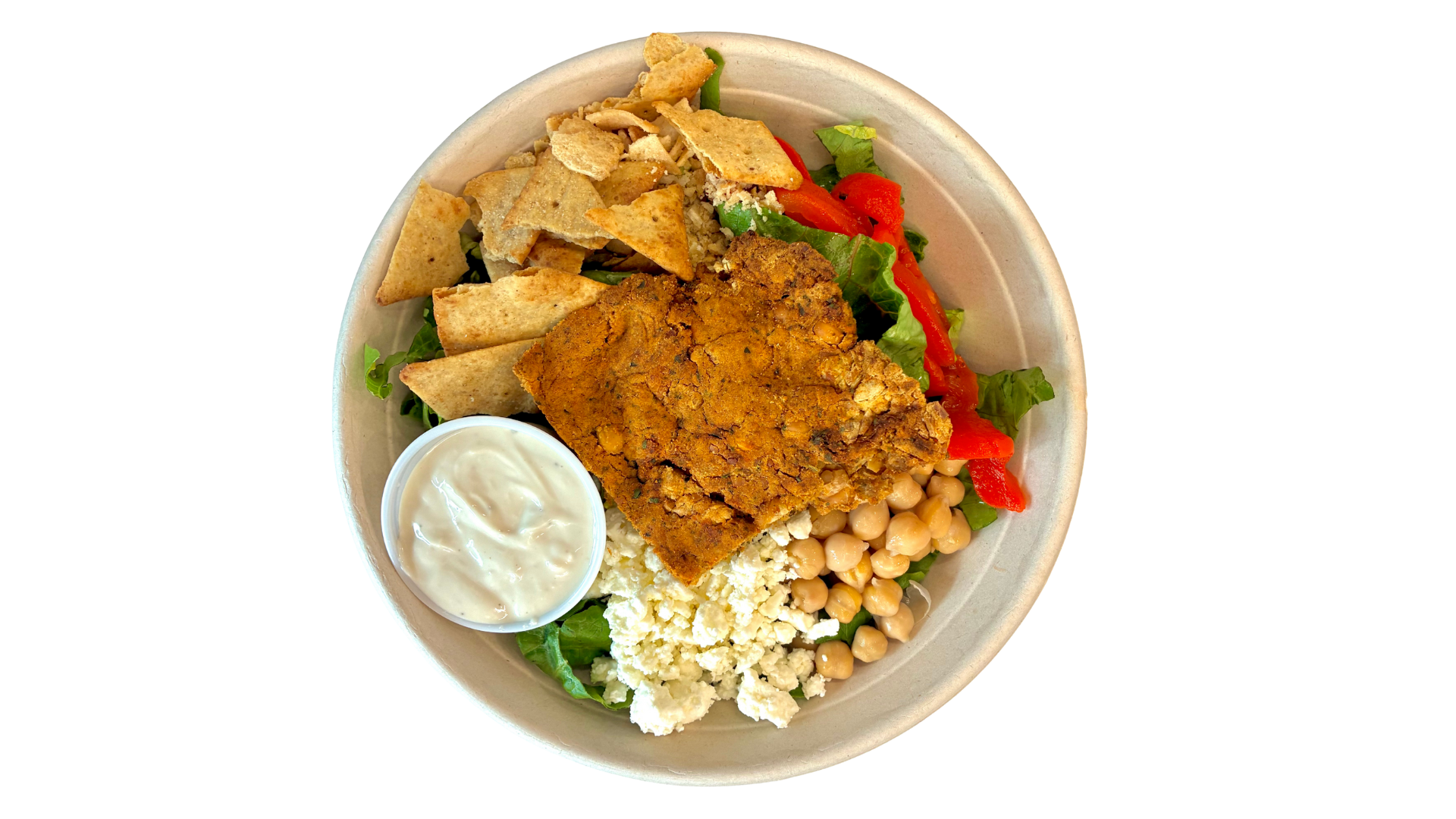 Mediterranean salad with fried fish fillet, pita chips, chickpeas, feta cheese, vegetables, and white dipping sauce in a bowl