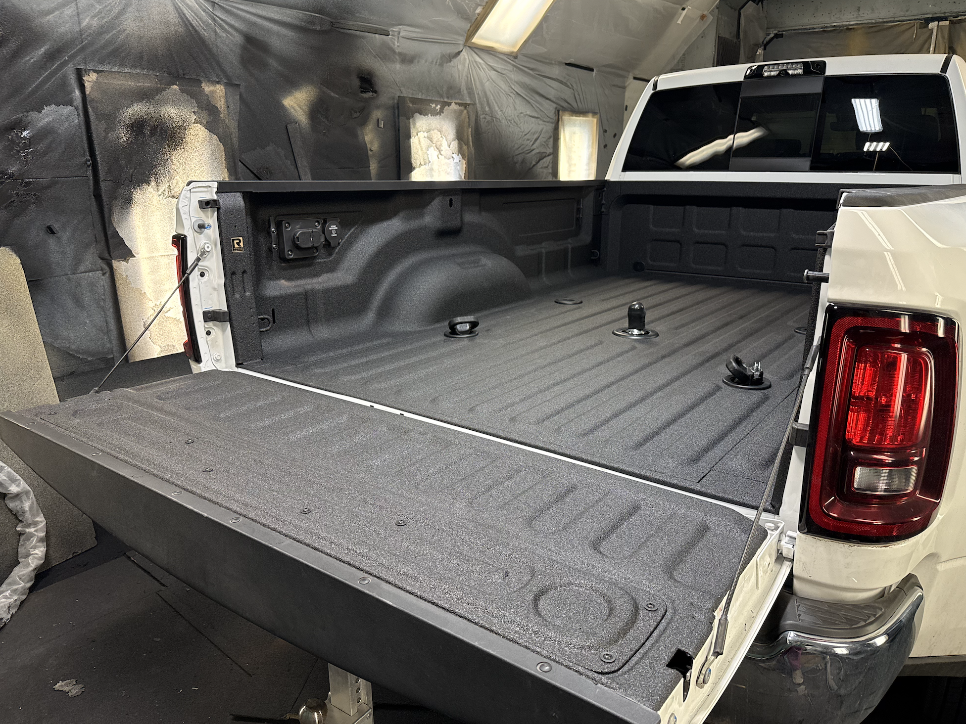 Industrial-grade spray-on polyurea bedliner coating applied to a pickup truck bed for durable, waterproof, and impact-resistant protection. Speedliner, Raptor Liner, Bullet Liner, Rhino Linings, Line-X