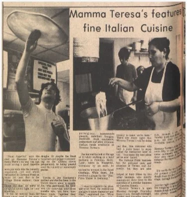 A newspaper clipping featuring a woman cooking in a kitchen with a headline about Mama Teresa's Italian cuisine.