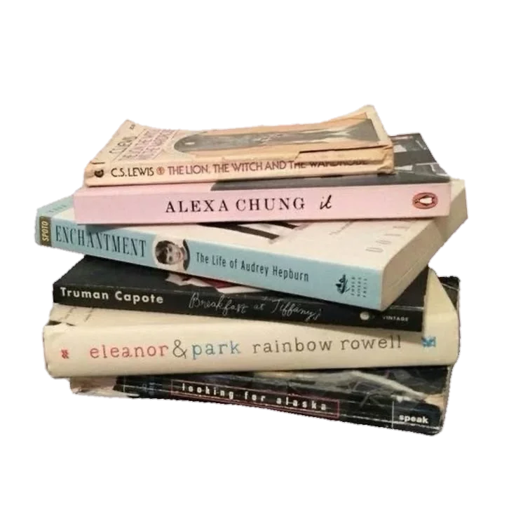 A stack of seven books on a surface, with some books slightly tilted or overlapping.