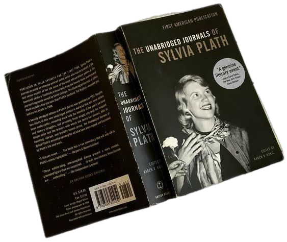 Book titled 'The Unabridged Journals of Sylvia Plath' with a black and white photo of Sylvia Plath on the cover, holding an ice cream cone and smiling.