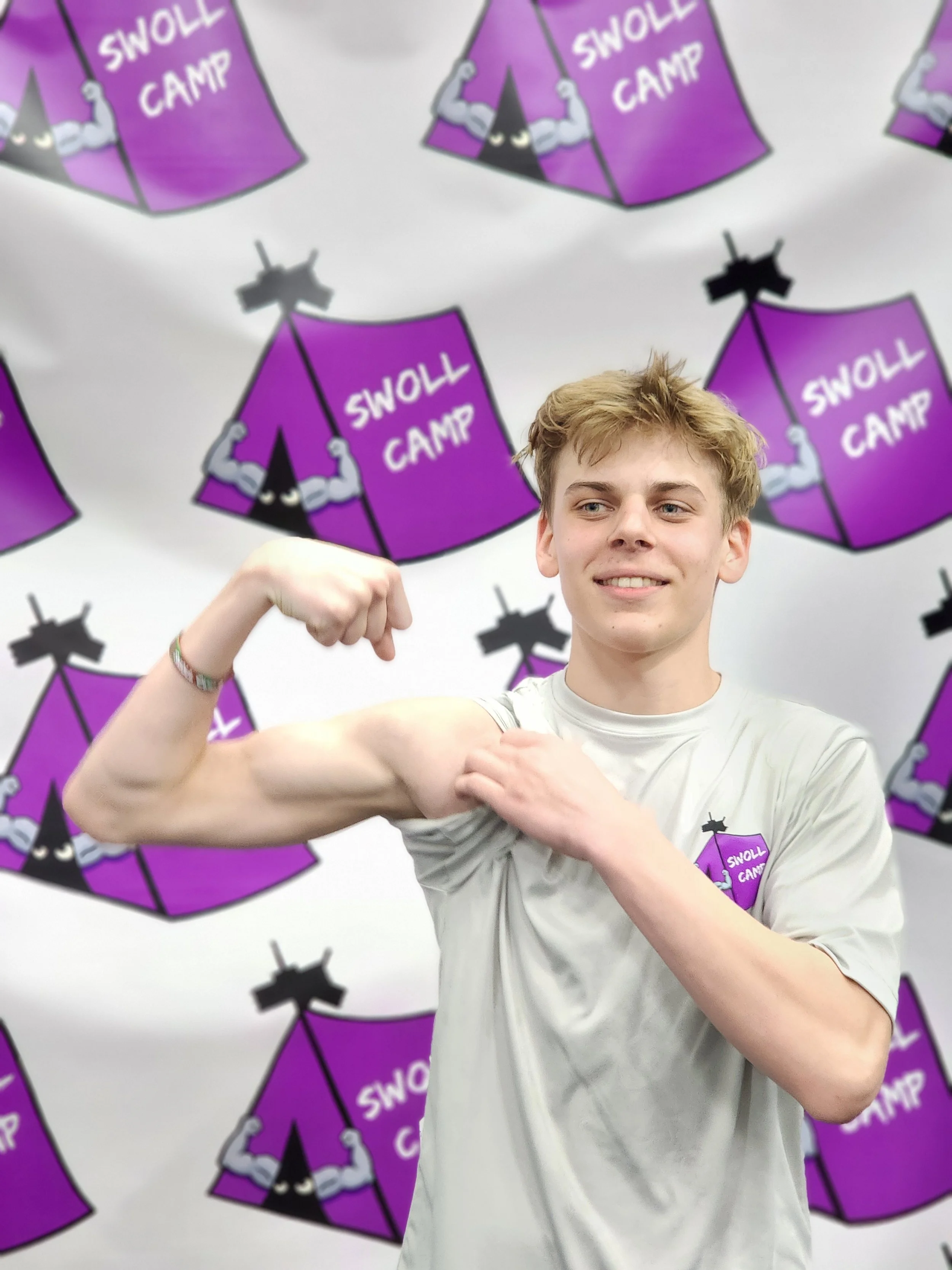 Student athlete proudly showing strength gains and increased confidence after training with Swoll Camp.