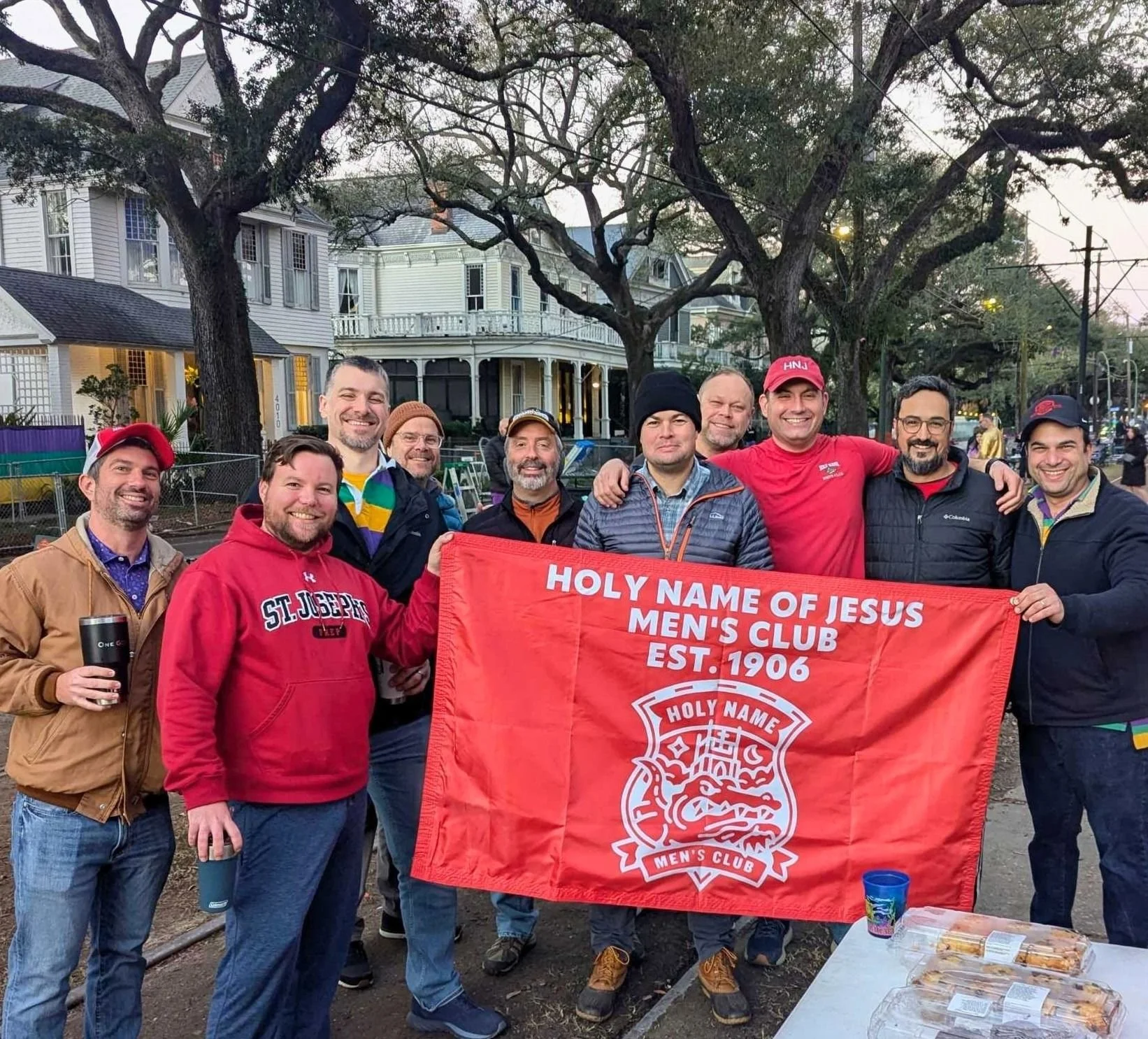 a bunch of handsome middle aged men getting ready to party on St Charles during Mardi Gras