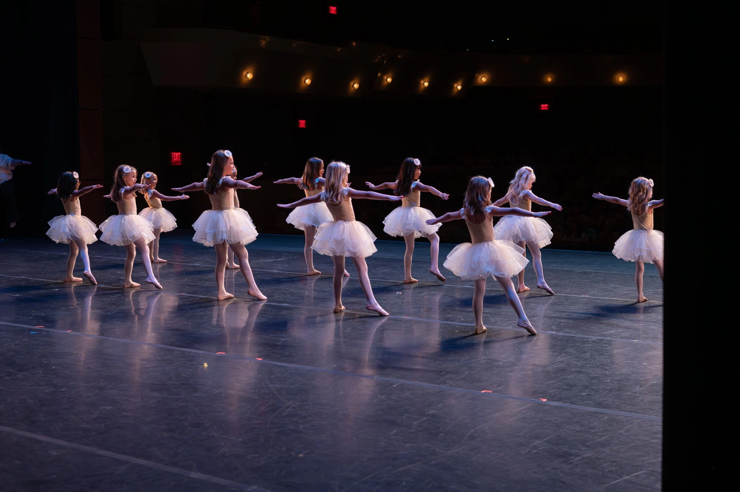 ballerinas performing on stage at their recital