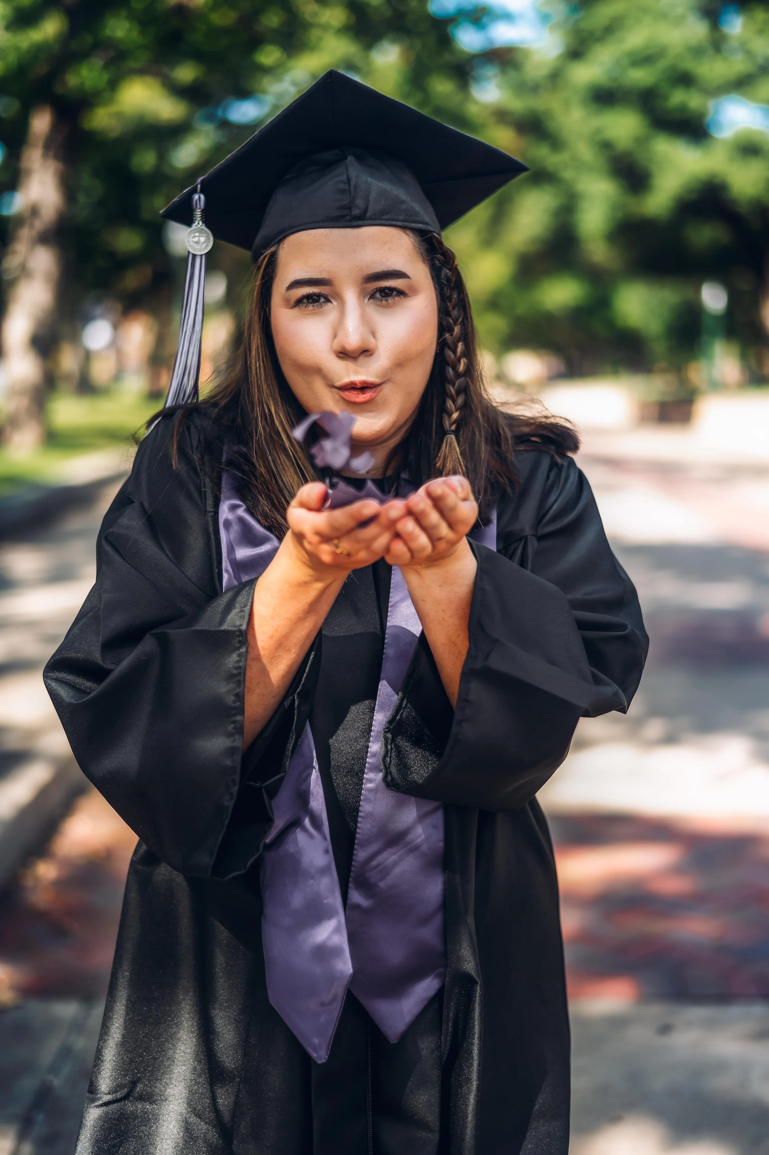 tarleton state university senior blowing confetti out of her hands