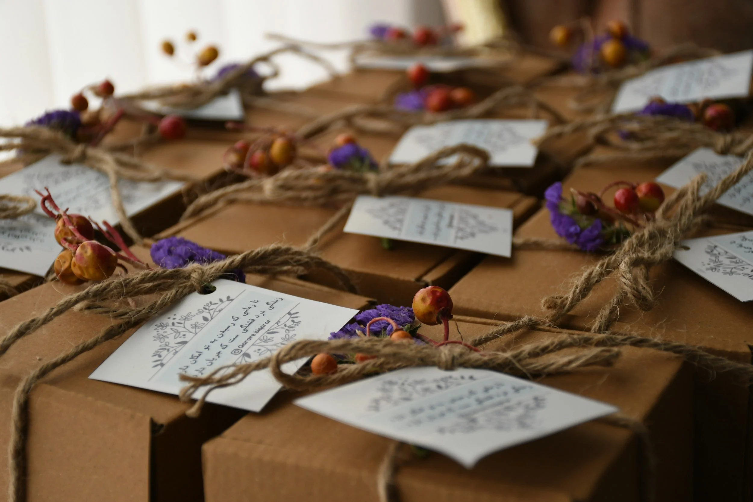 Gift boxes wrapped with twine and handwritten notecards