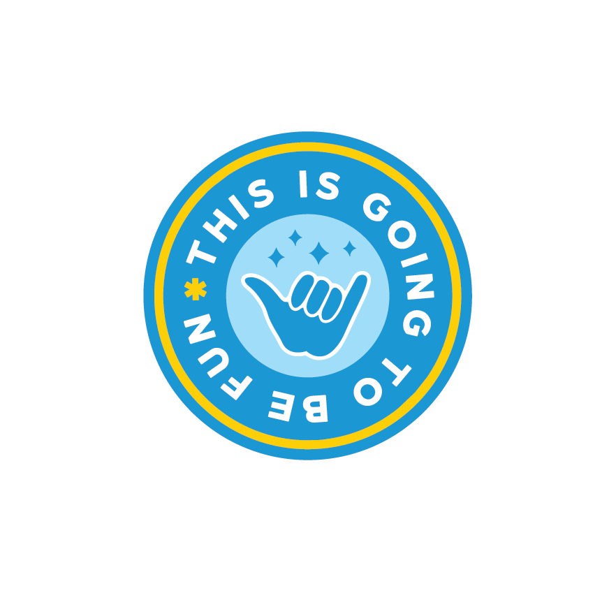 Circular badge with a blue background, white text reading 'THIS IS GOING TO BE FUN', and a shaka hand sign in the center surrounded by small squiggles. The badge has a yellow and white border.