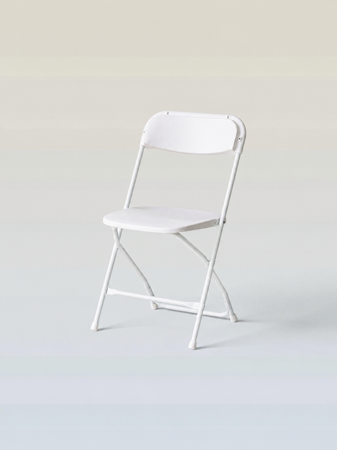 White folding chair against a plain light background.