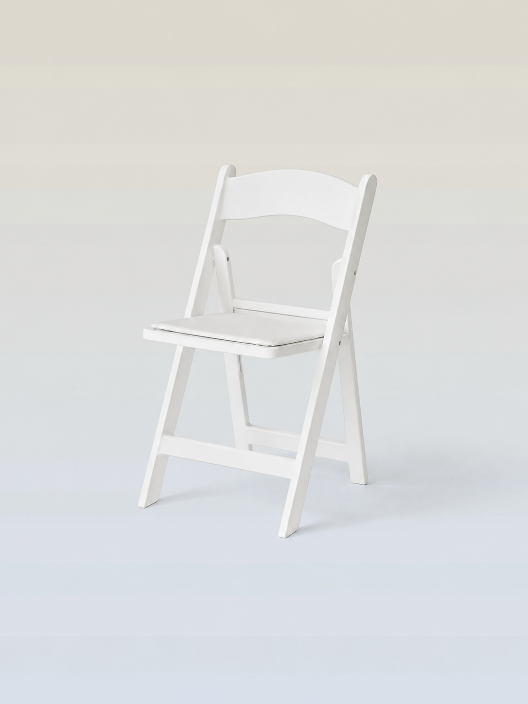 White wooden folding chair placed on a light-colored background.