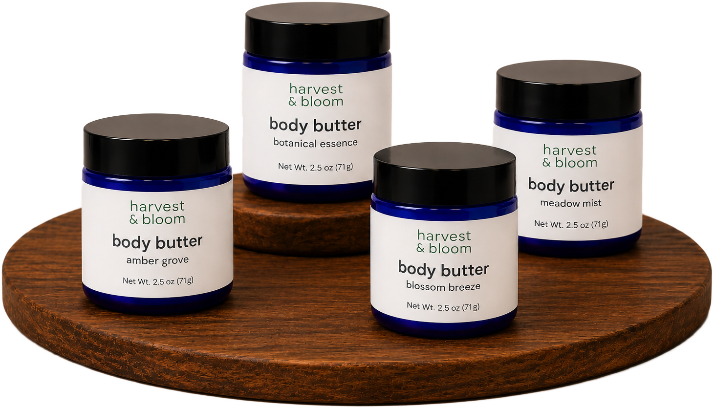 Four cobalt blue glass jars of Harvest & Bloom whipped tallow body butter displayed on tiered wooden risers, available in Amber Grove, Botanical Essence, Blossom Breeze, and Meadow Mist scents.