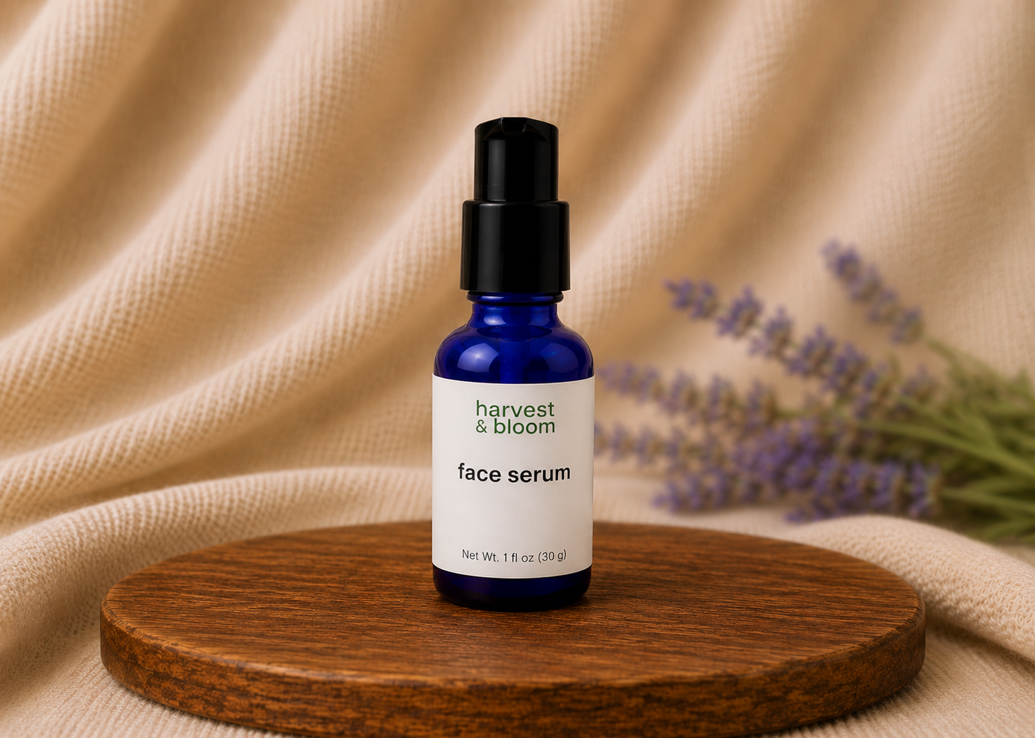 Harvest and Bloom natural face serum in a compact blue glass bottle with a black treatment pump dispenser against a soft fabric backdrop.