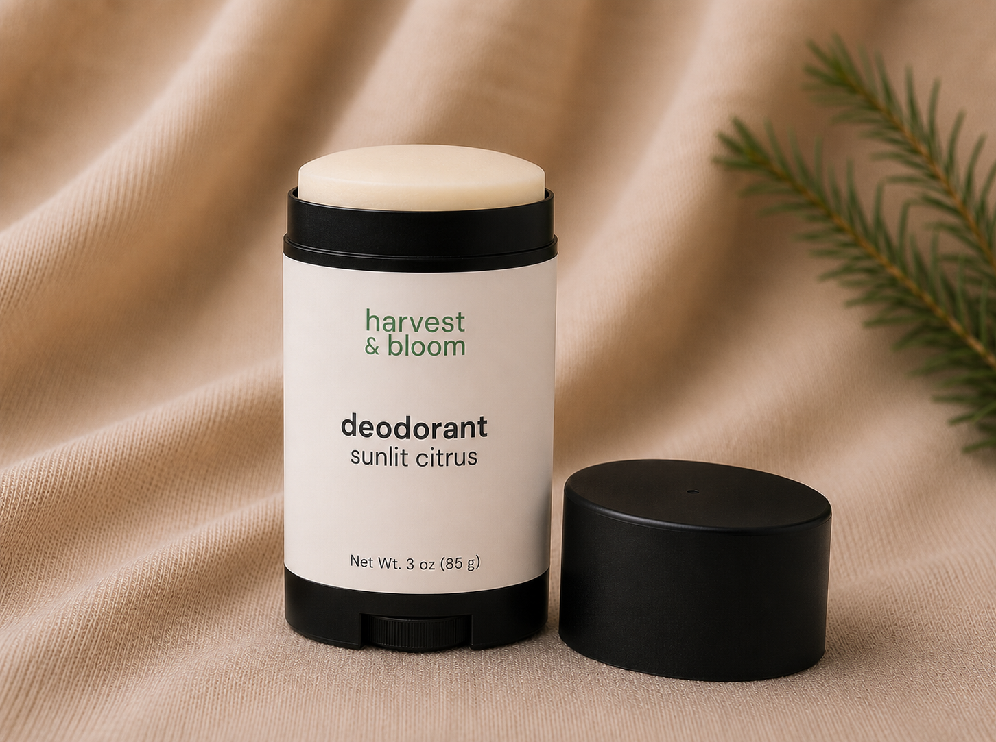 A close-up view of an open Harvest & Bloom botanical deodorant stick showing a smooth, creamy, baking soda-free texture.