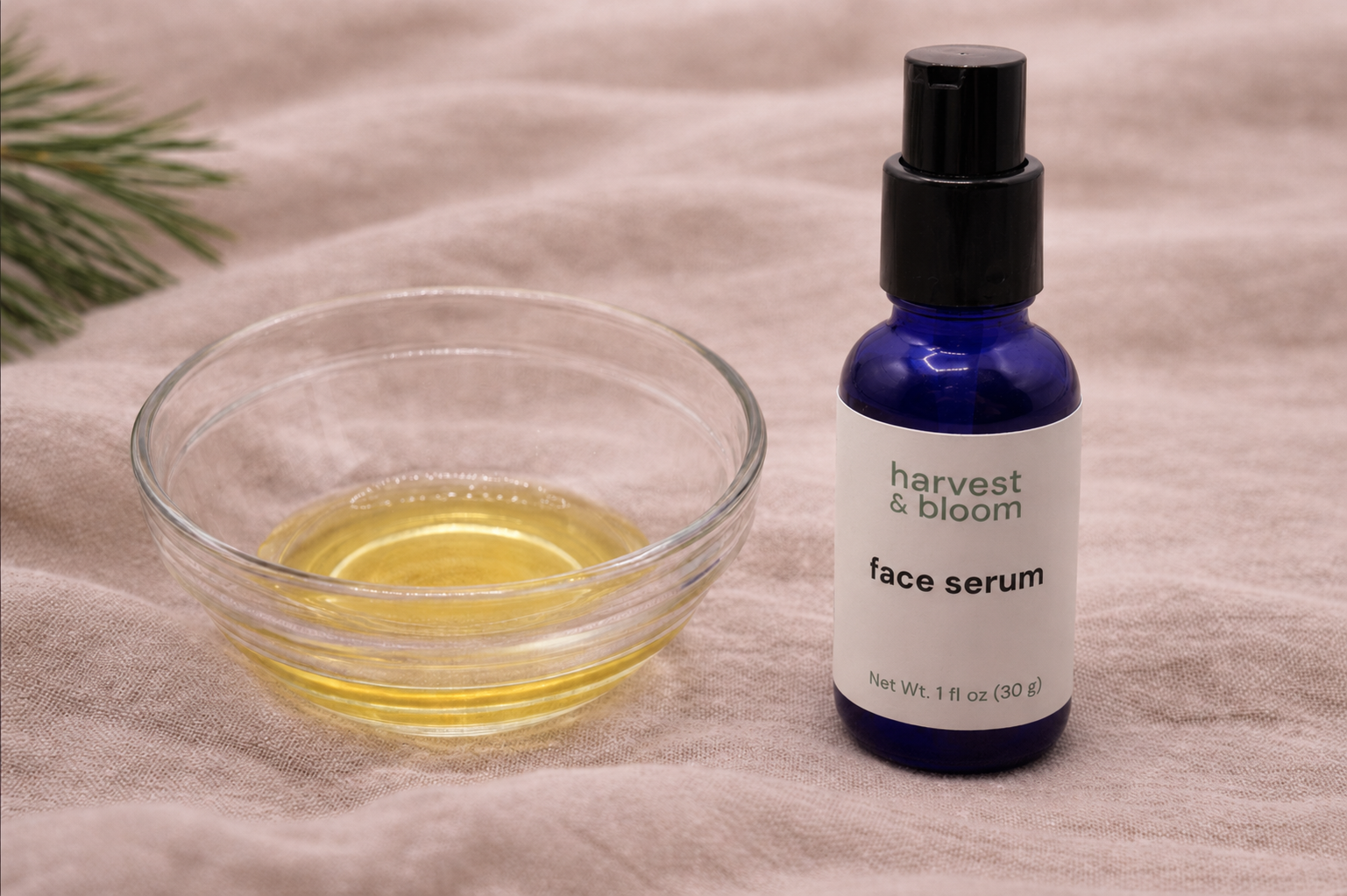 A close-up view highlighting a silky, golden droplet of waterless rosehip and argan face serum treatment on a smooth background.