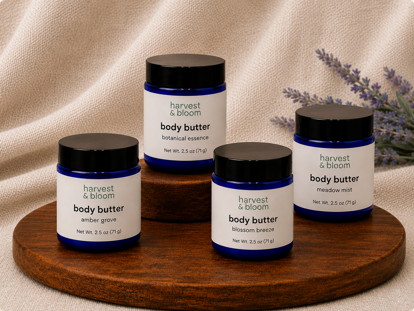 Four blue glass jars of Harvest and Bloom whipped tallow body butter in a professional product lineup with elegant black lids.