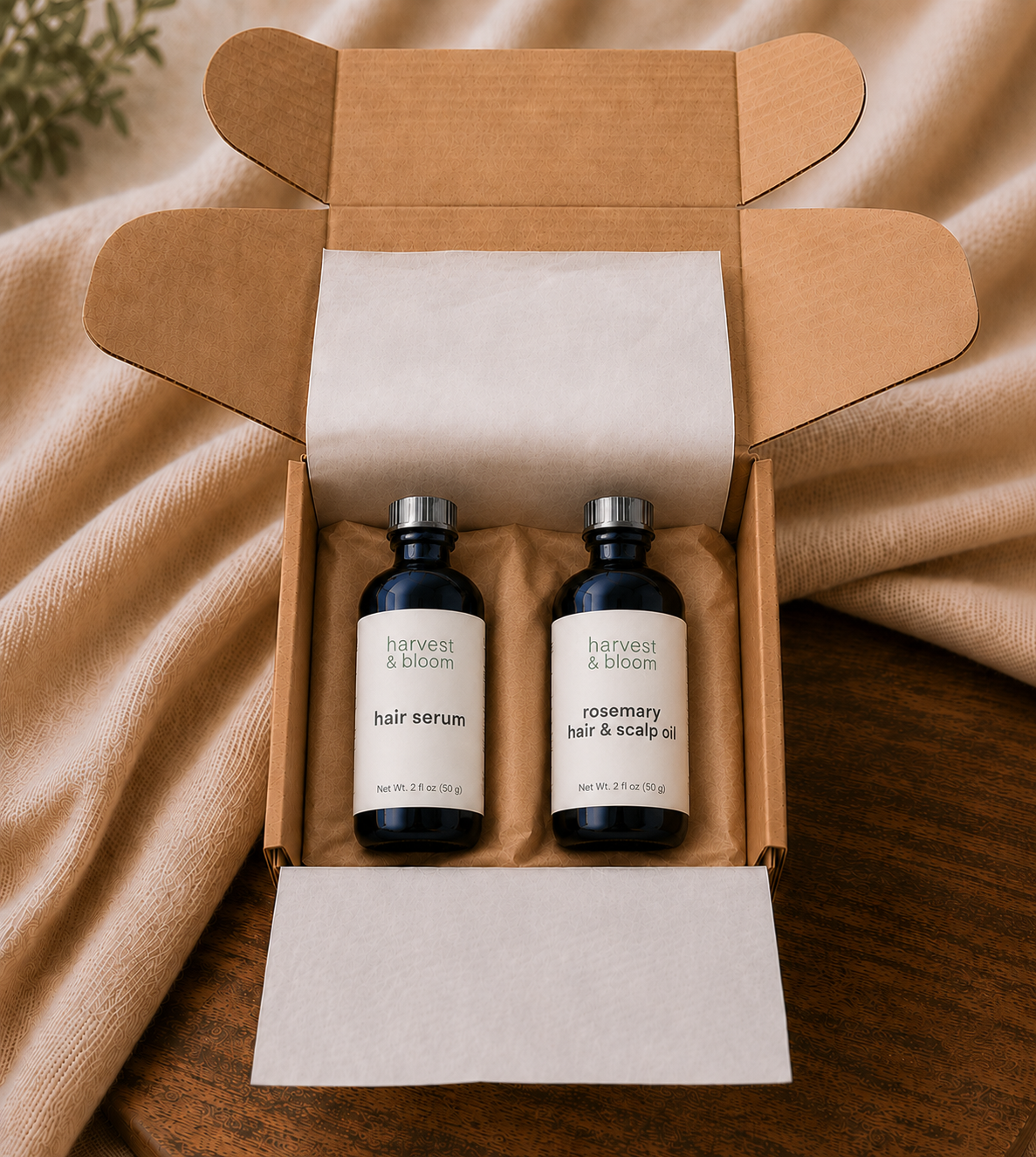 A curated natural hair care gift set featuring full-size botanical hair serum and slow-infused rosemary scalp oil packaged together for an artisanal hair ritual.
