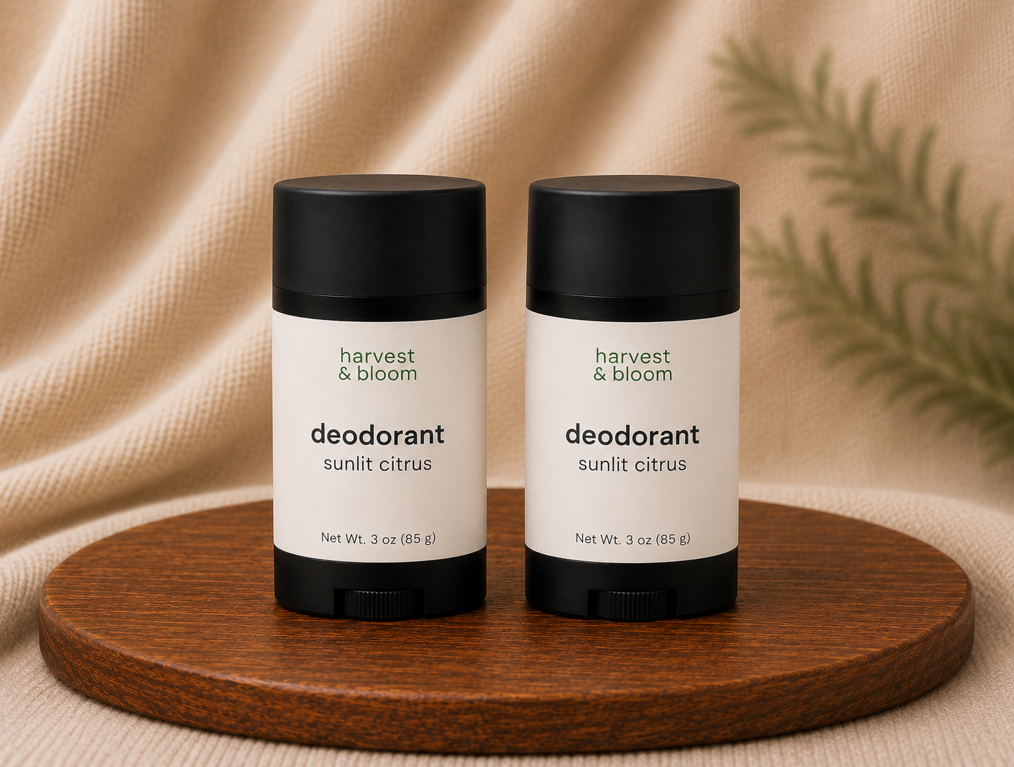 Harvest and Bloom natural deodorant duo set featuring two full-size twist-up tubes displayed side by side on a wooden tray.