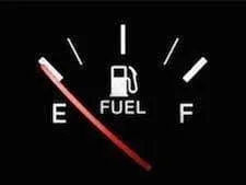 Car's fuel gauge showing low fuel level near empty