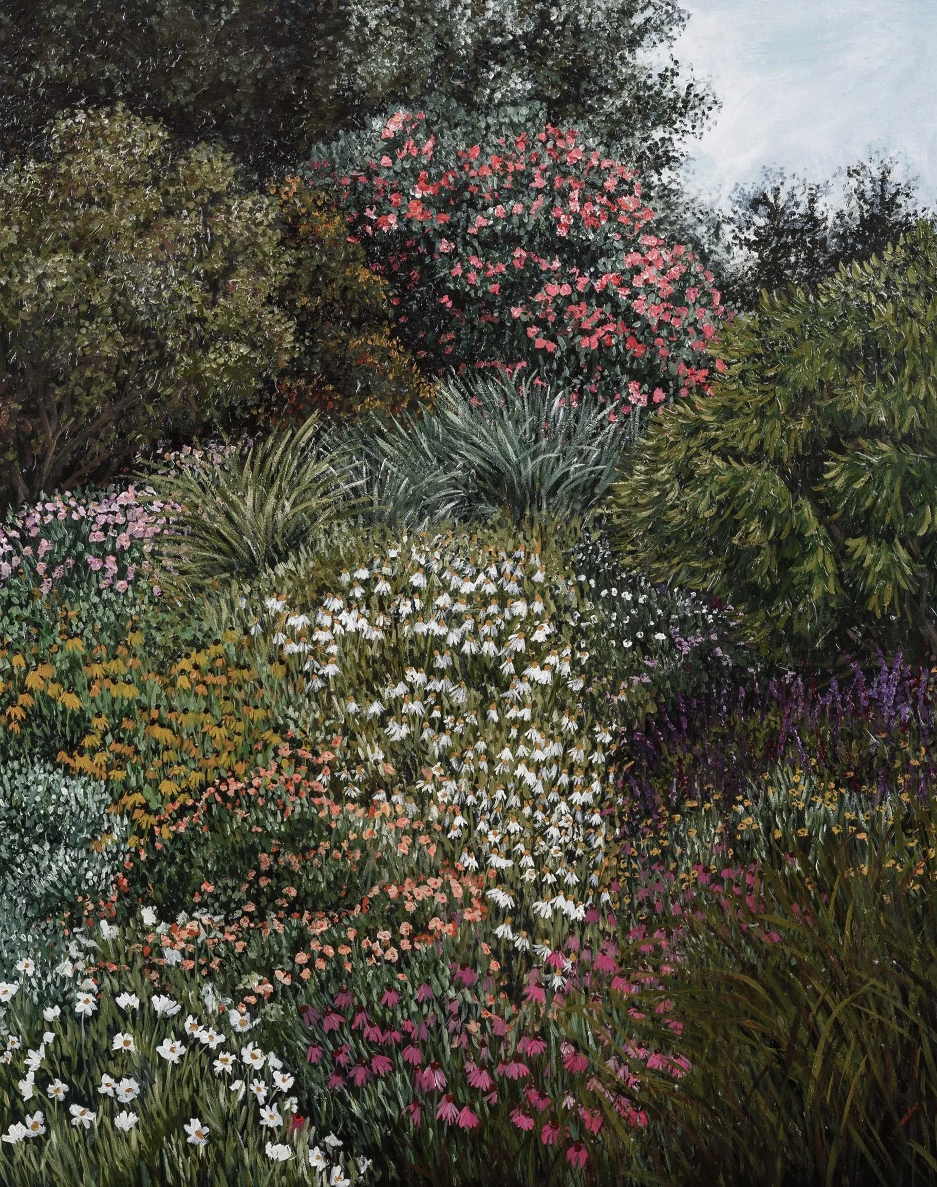 A lush garden filled with various flowering plants and trees, including a large tree with a bush of pink flowers, surrounded by smaller white, purple, and yellow flowers.