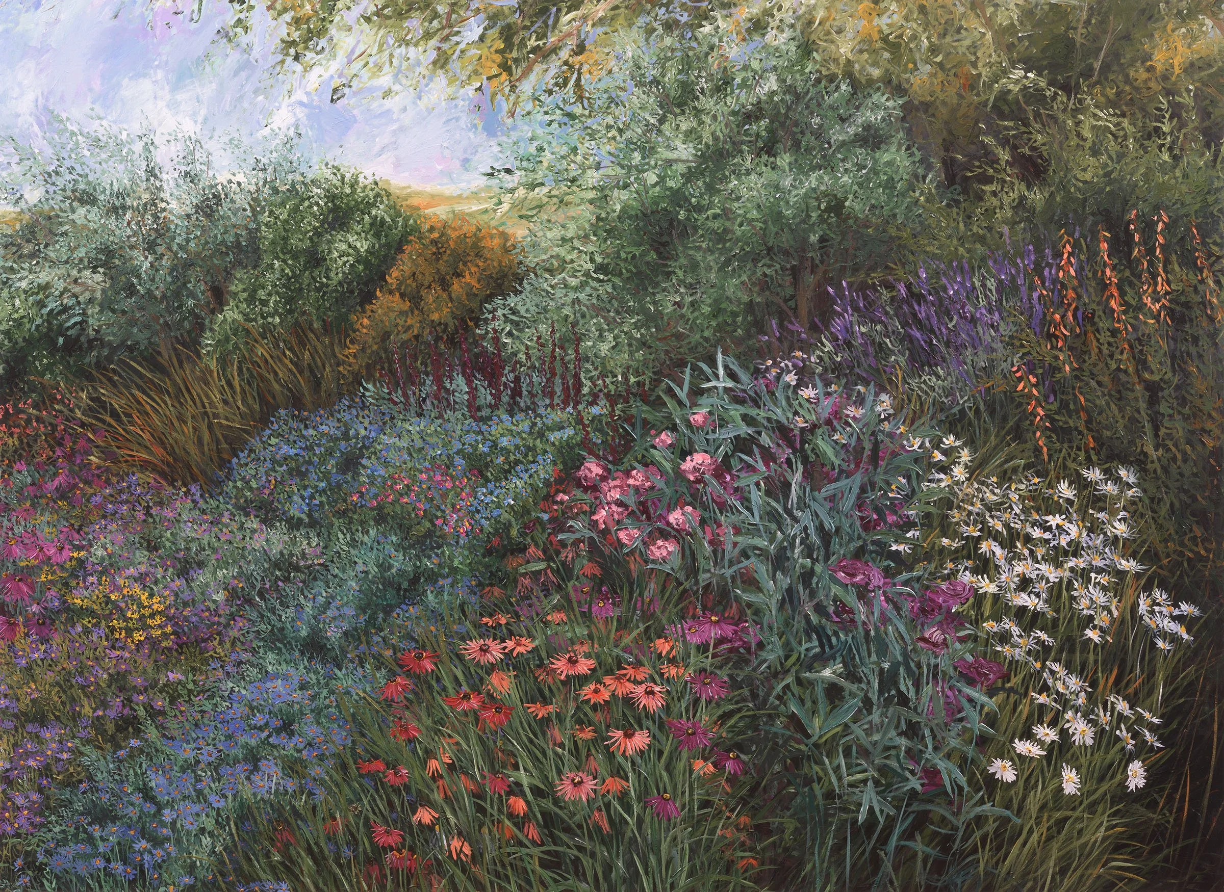 A vibrant garden filled with a variety of colorful flowers and lush green foliage.