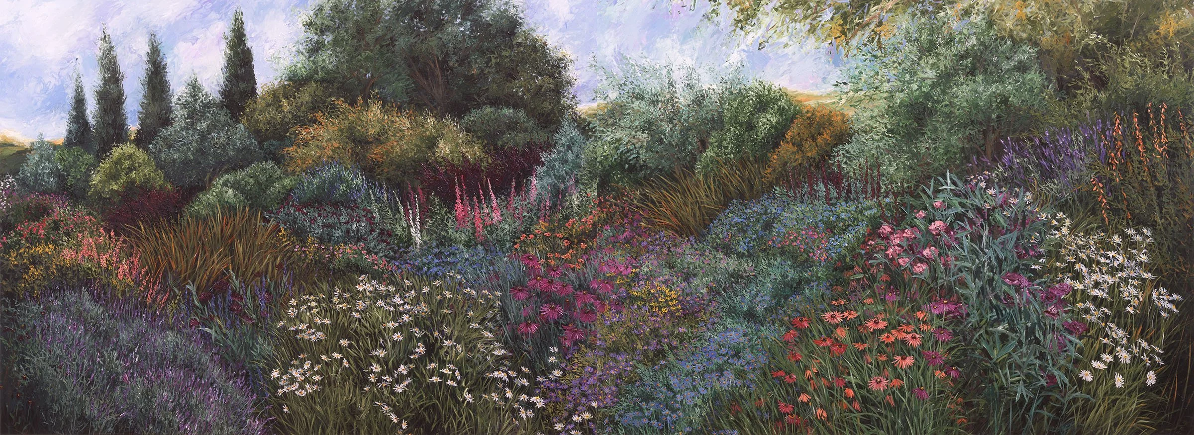 A colorful garden with various flowers and lush green trees under a cloudy sky.