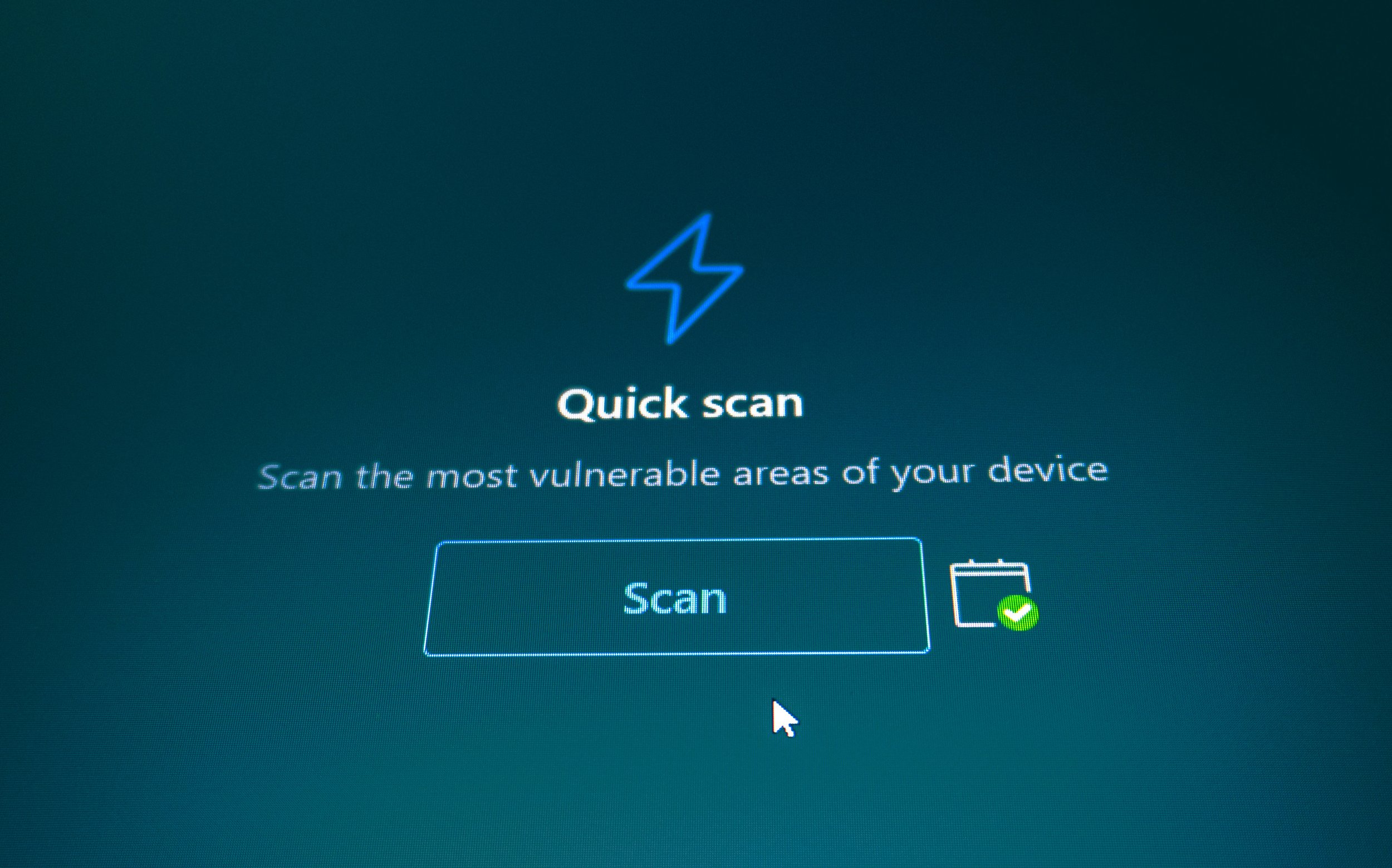 A screen displaying a security software "Quick Scan" prompt, with a Scan button and a scheduled scan icon.