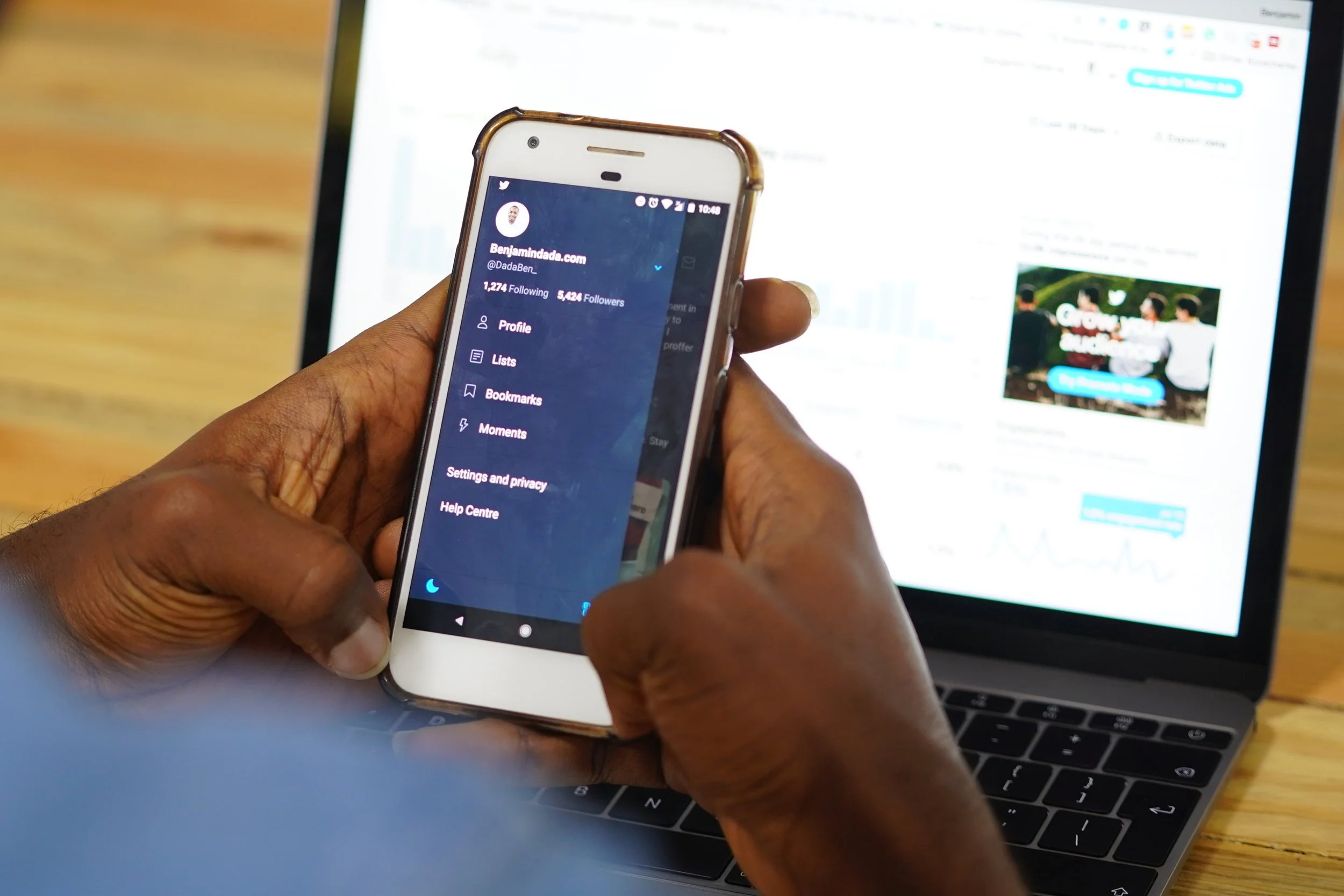 a person using the Twitter mobile app in dark mode.