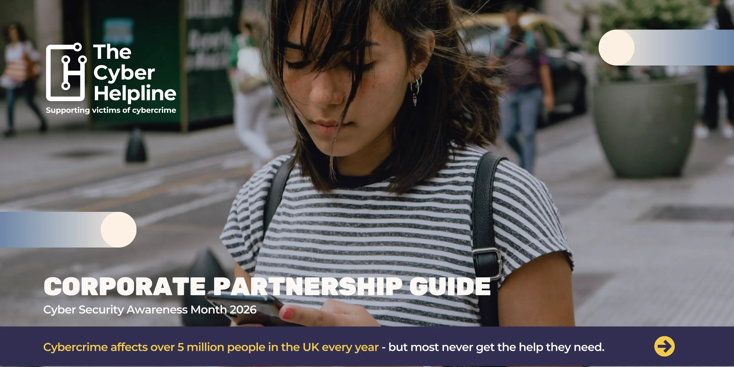 A young woman with dark hair wearing a striped t-shirt and earrings looks at her phone while walking outdoors on a city street. An overlay on the image promotes The Cyber Helpline's corporate partnership guide for Cyber Security Awareness Month 2026, and mentions the impact of cybercrime.