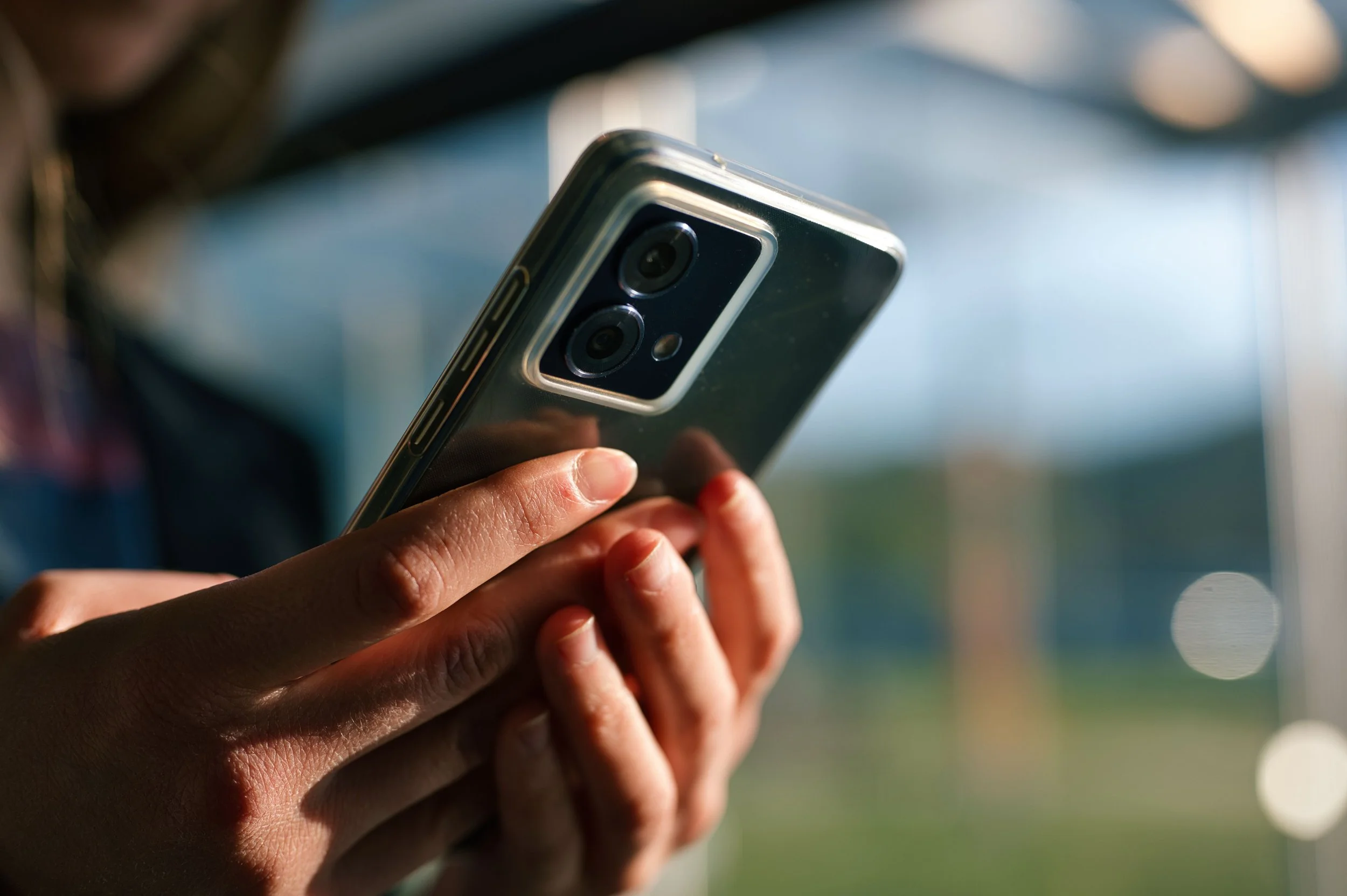 Close-up of a person’s hands holding an Android phone.