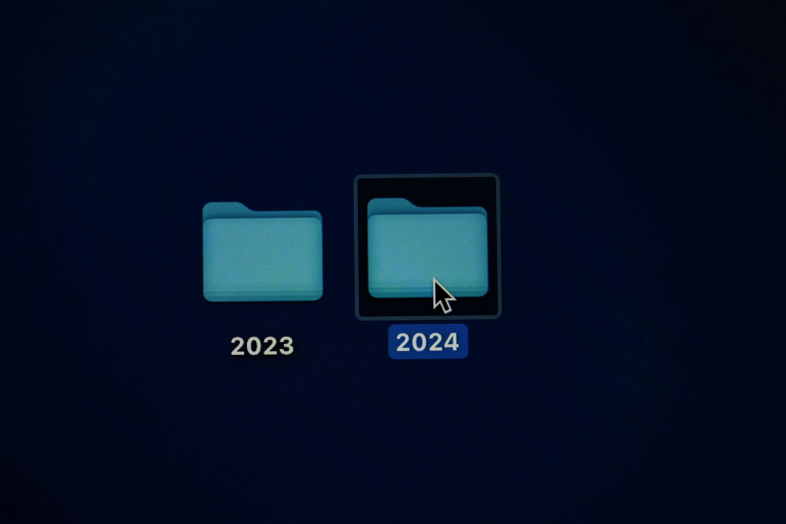 A Mac desktop showing two folders labelled "2023" and "2024", with the 2024 folder selected.