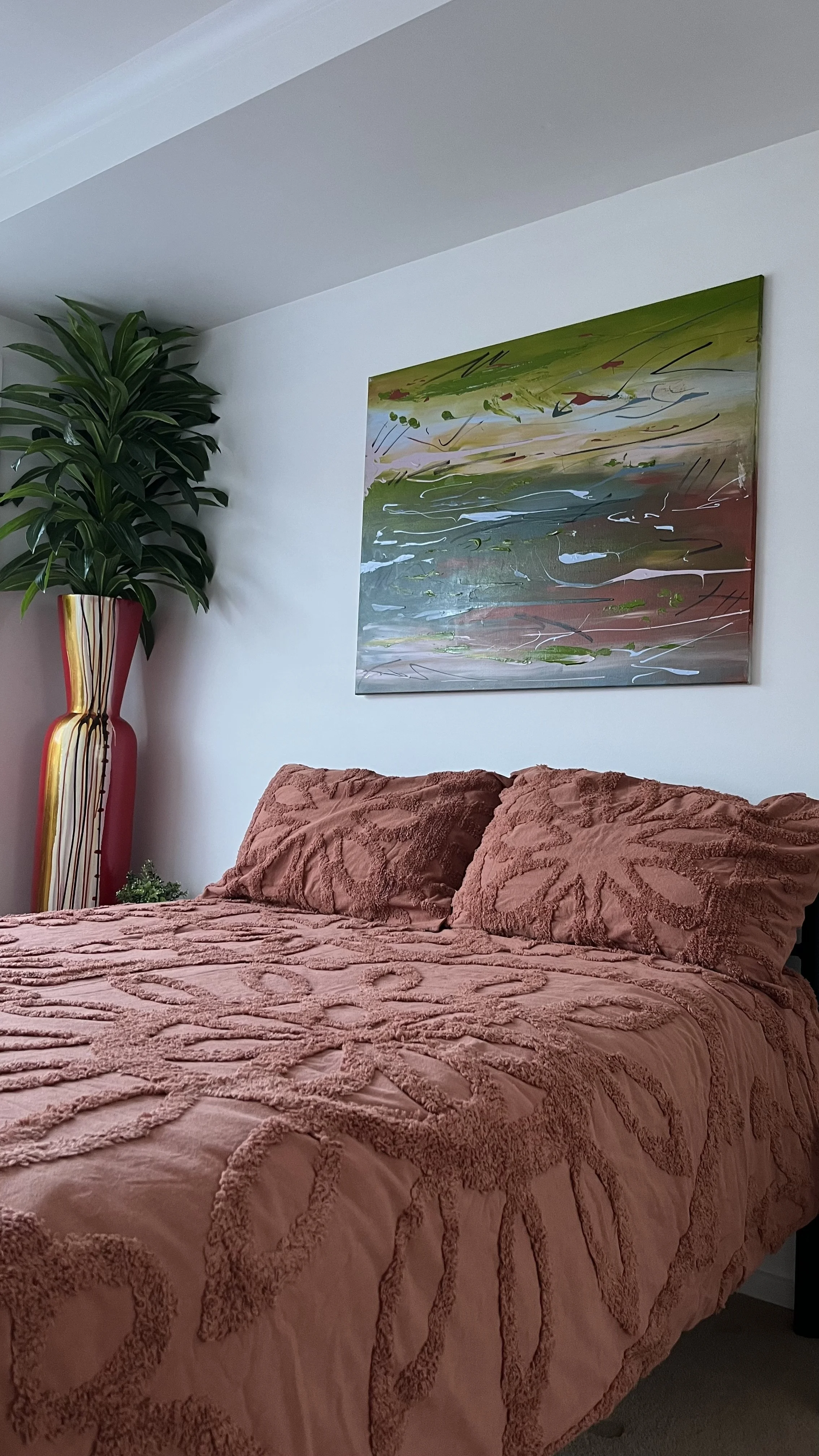 painting on wall above a bed